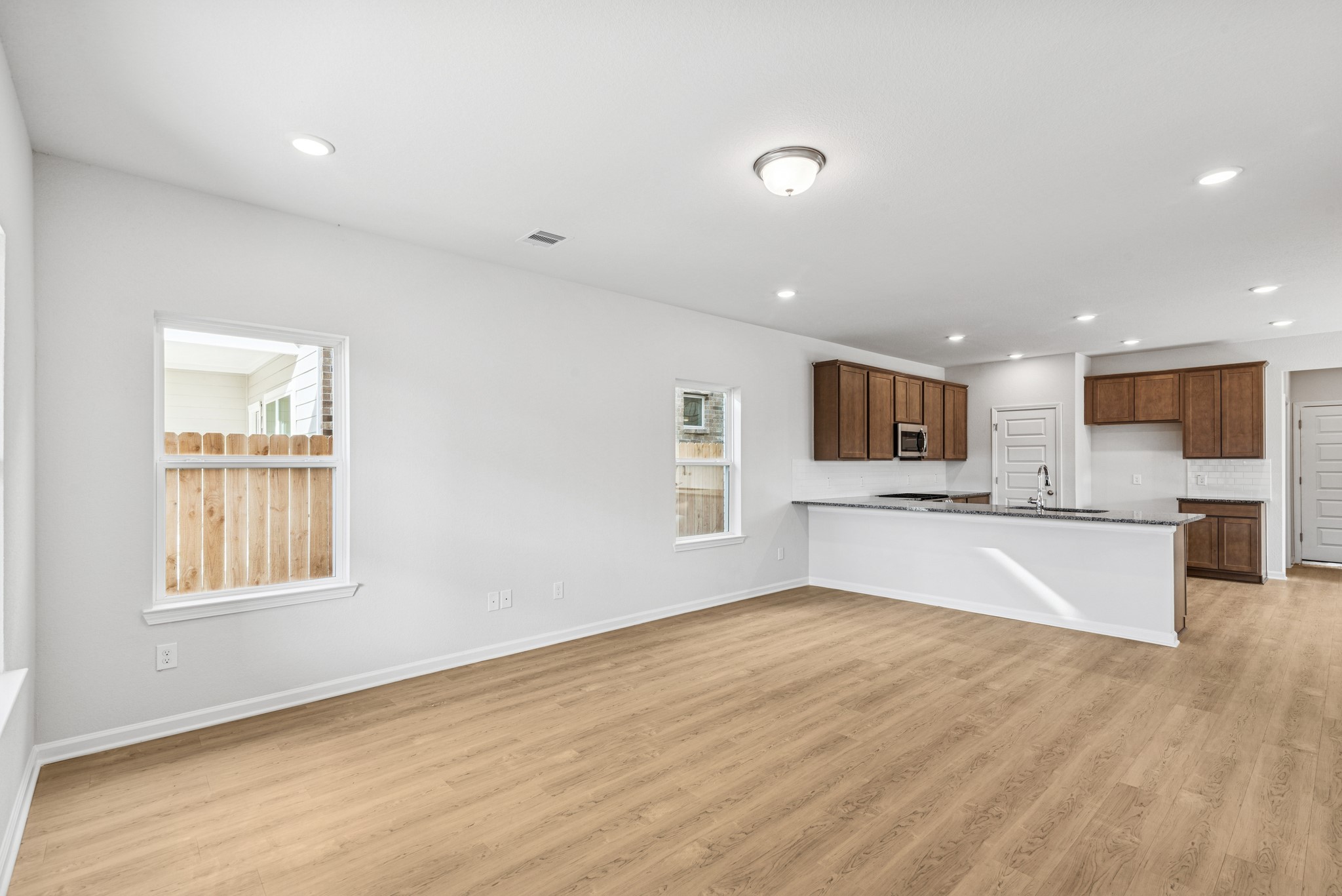 9745 Enclave Ridge Road Willis, TX 77318 - Photo 9 of 27 a view of kitchen with window and wooden floor