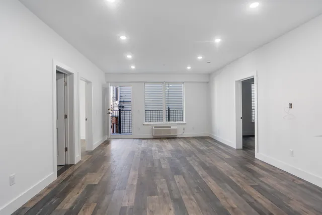 a view of wooden floor and windows in an empty room