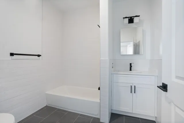 a bathroom with a bathtub and a sink
