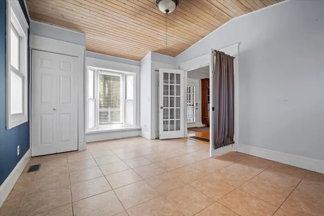 an empty room with entrance and windows