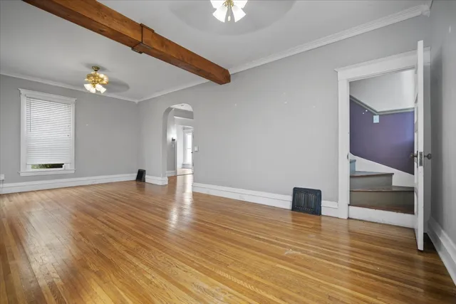 wooden floor in an empty room with a window