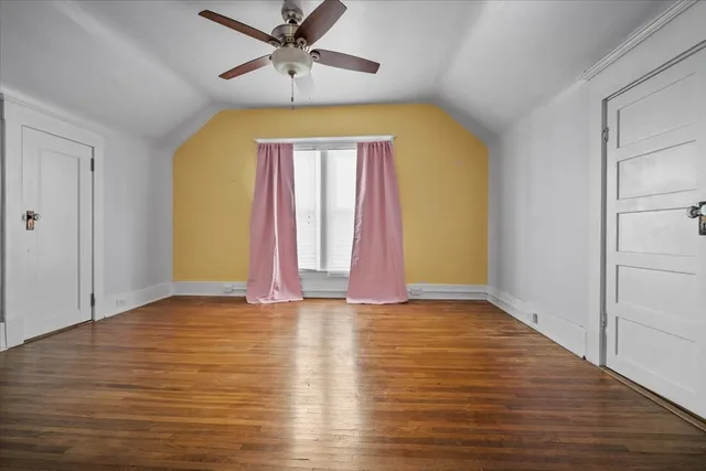a view of room with window and wooden floor