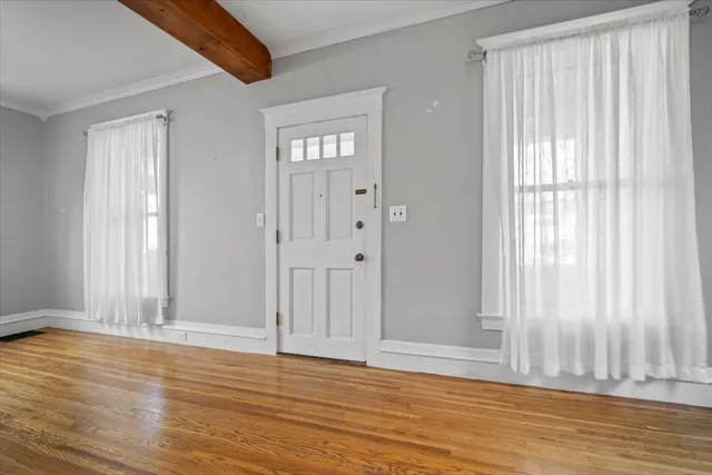 a view of wooden floor and windows in a room