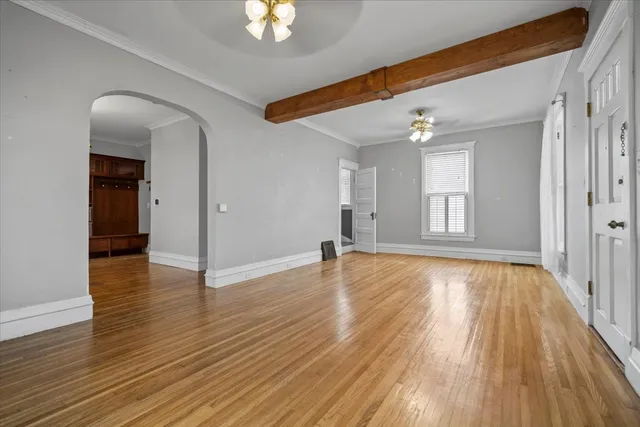 wooden floor in an empty room with a window
