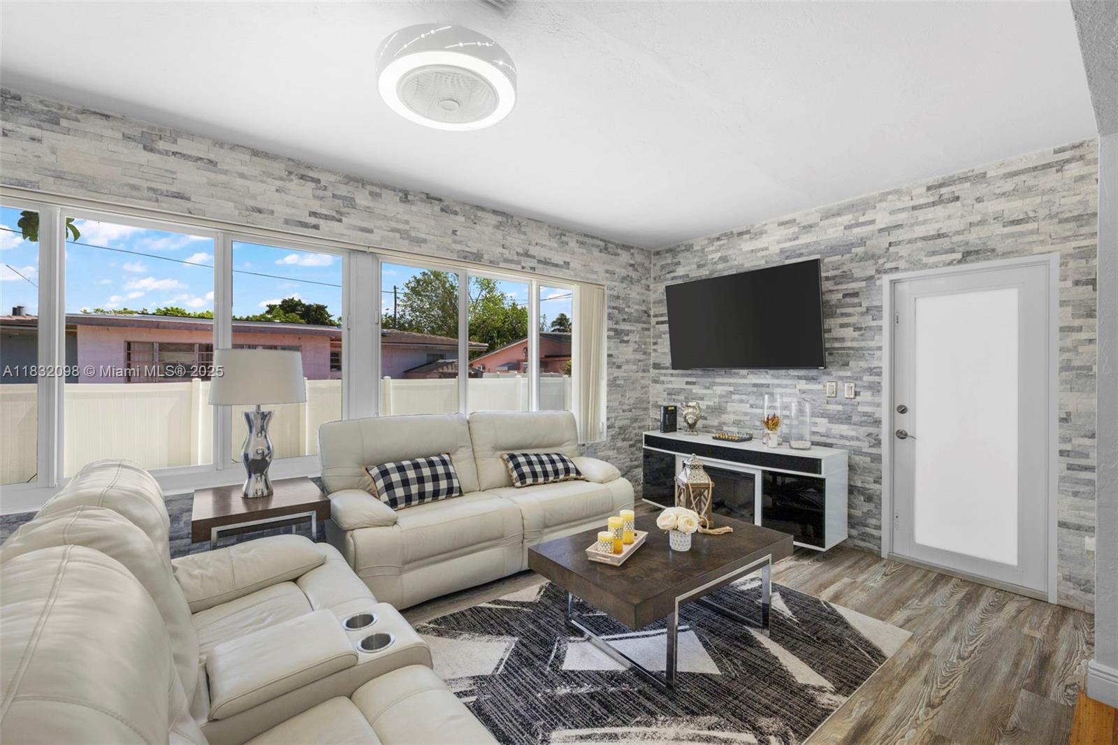 8631 Southwest 16th Terrace Miami, FL 33155 - Photo 13 of 61 a living room with furniture a fireplace and a flat screen tv