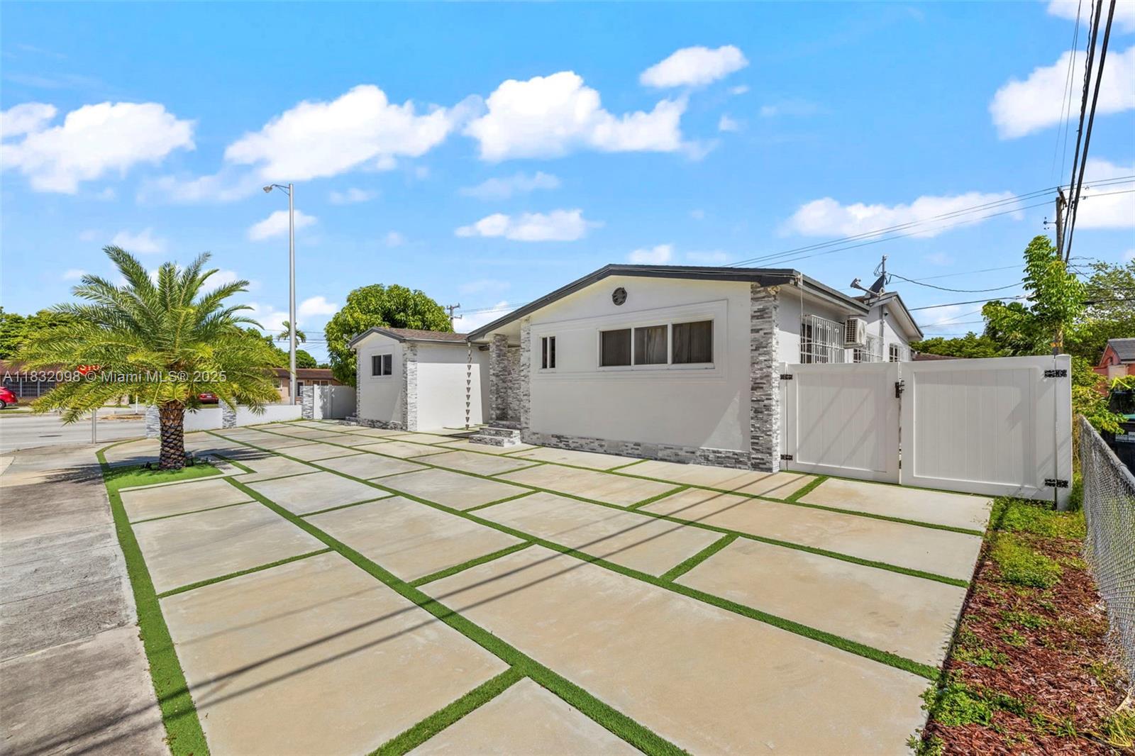 8631 Southwest 16th Terrace Miami, FL 33155 - Photo 2 of 61 a view of a white house with a yard