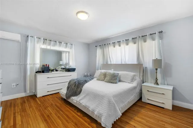 a living room with stainless steel appliances furniture a rug and a flat screen tv