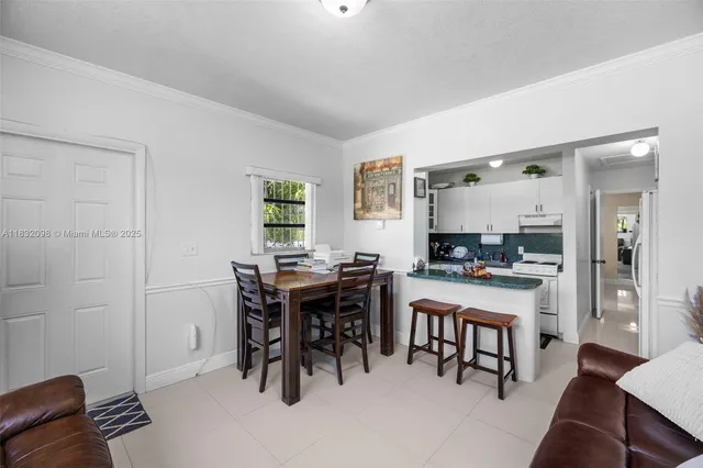 a utility room with fridge dryer and washer