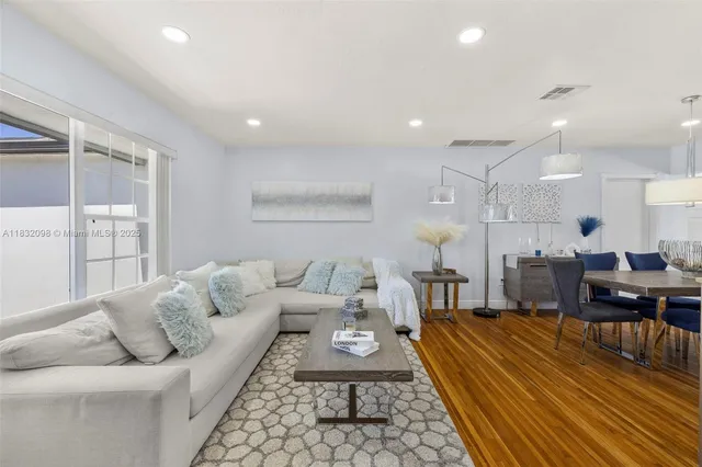 a dining room with stainless steel appliances granite countertop furniture and a kitchen view