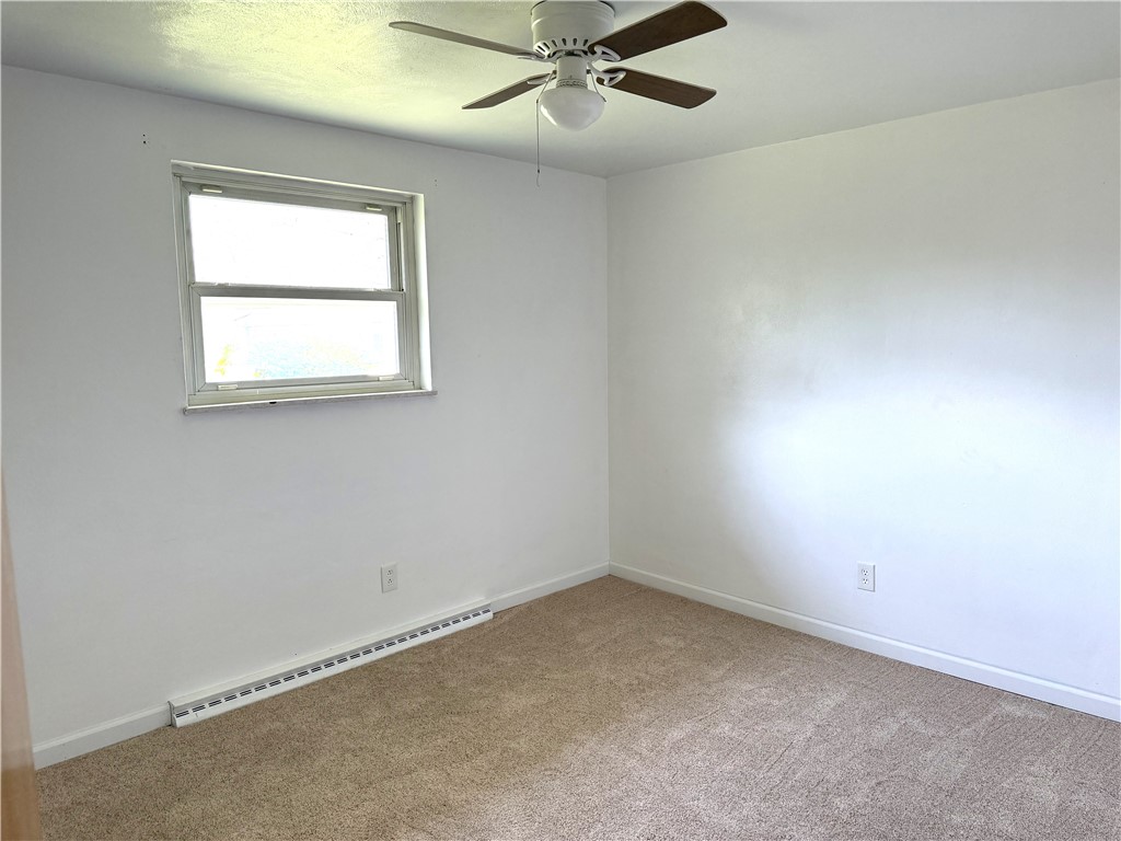 4732 Lehigh Drive Springfield, OH 45503 - Photo 10 of 27 This spacious room features a ceiling fan, plush carpet, and a window for natural light.
