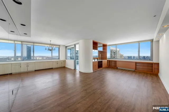 a kitchen with granite countertop a stove and wooden floor