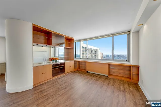 a view of room with window and wooden floor