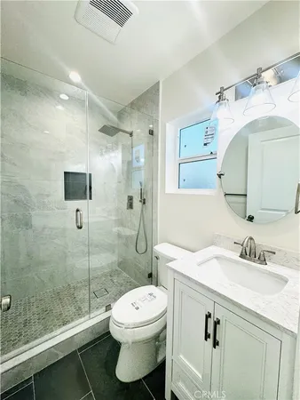 a bathroom with a sink toilet and shower