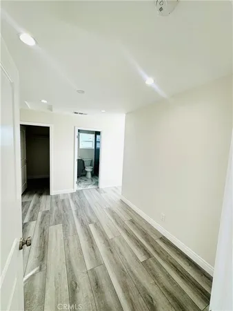 a view of a room with wooden floor and a window