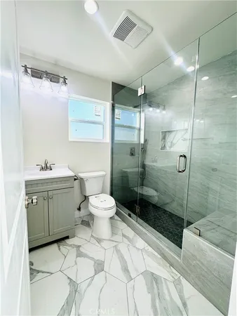 a bathroom with a sink toilet and shower
