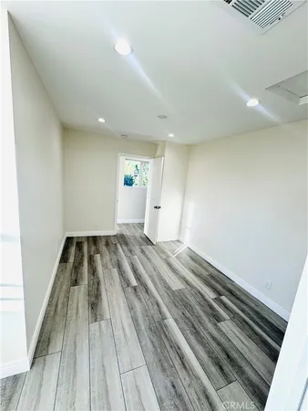 a view of wooden floor in an empty room