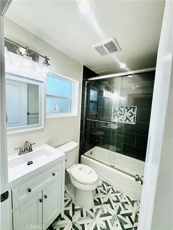 a bathroom with a sink toilet a mirror and shower