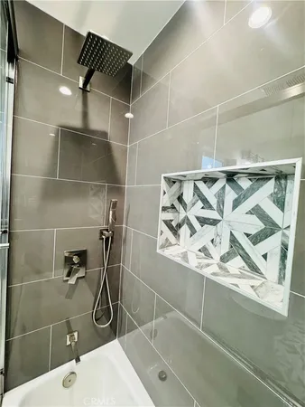 a bathroom with a shower and a sink