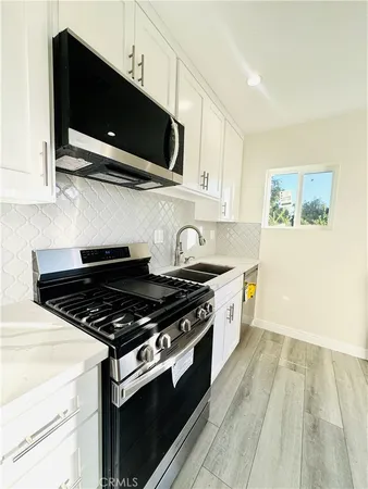 a kitchen with stainless steel appliances a stove a microwave and cabinets