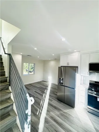 a kitchen with stainless steel appliances a refrigerator and a stove top oven