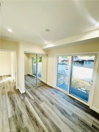 a view of an empty room and wooden floor