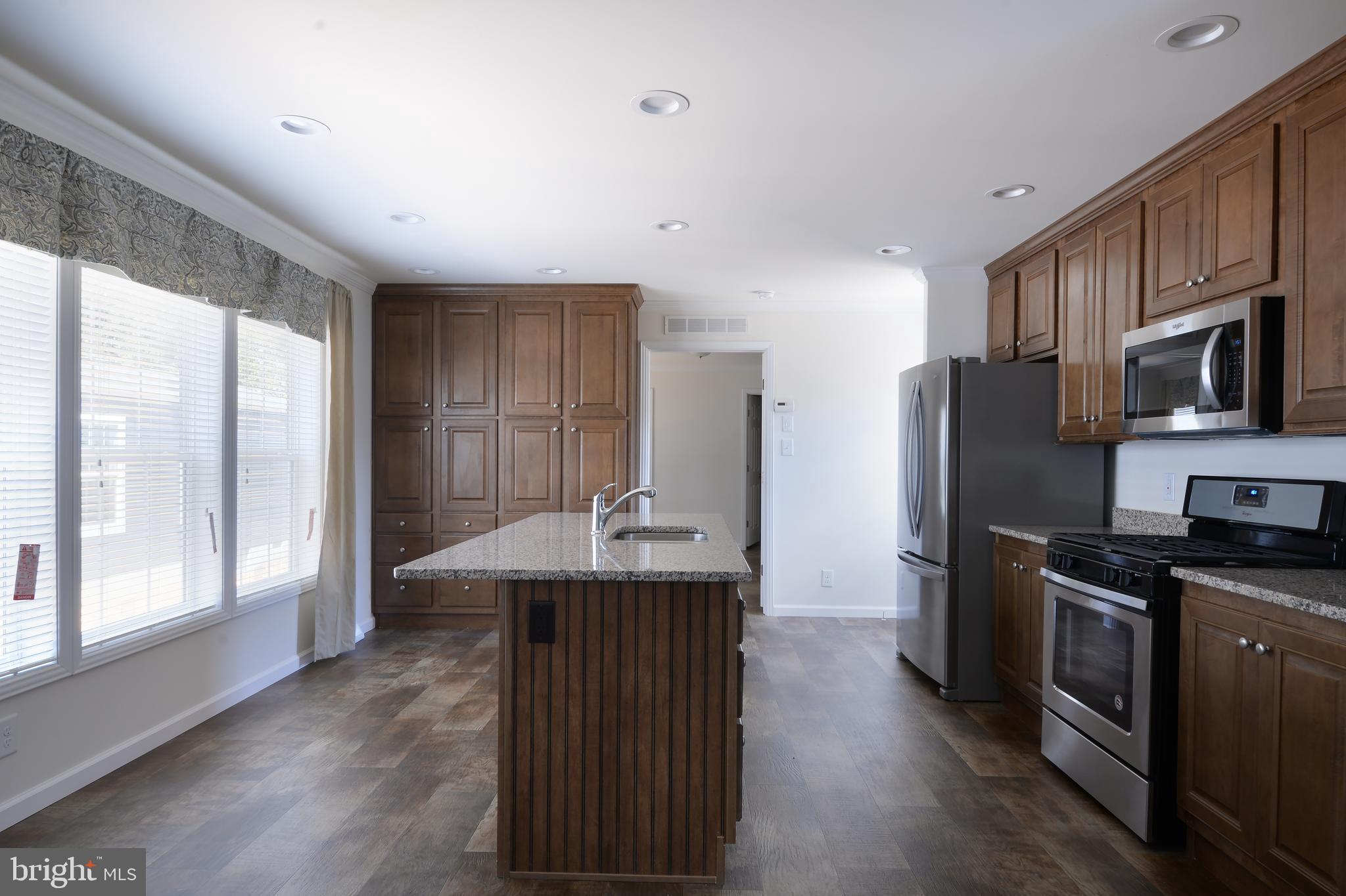 8 Edgewater Drive, Unit 8 Magnolia, DE 19962 - Photo 2 of 13 a kitchen with stainless steel appliances granite countertop a refrigerator a sink dishwasher a stove and a refrigerator with wooden floor