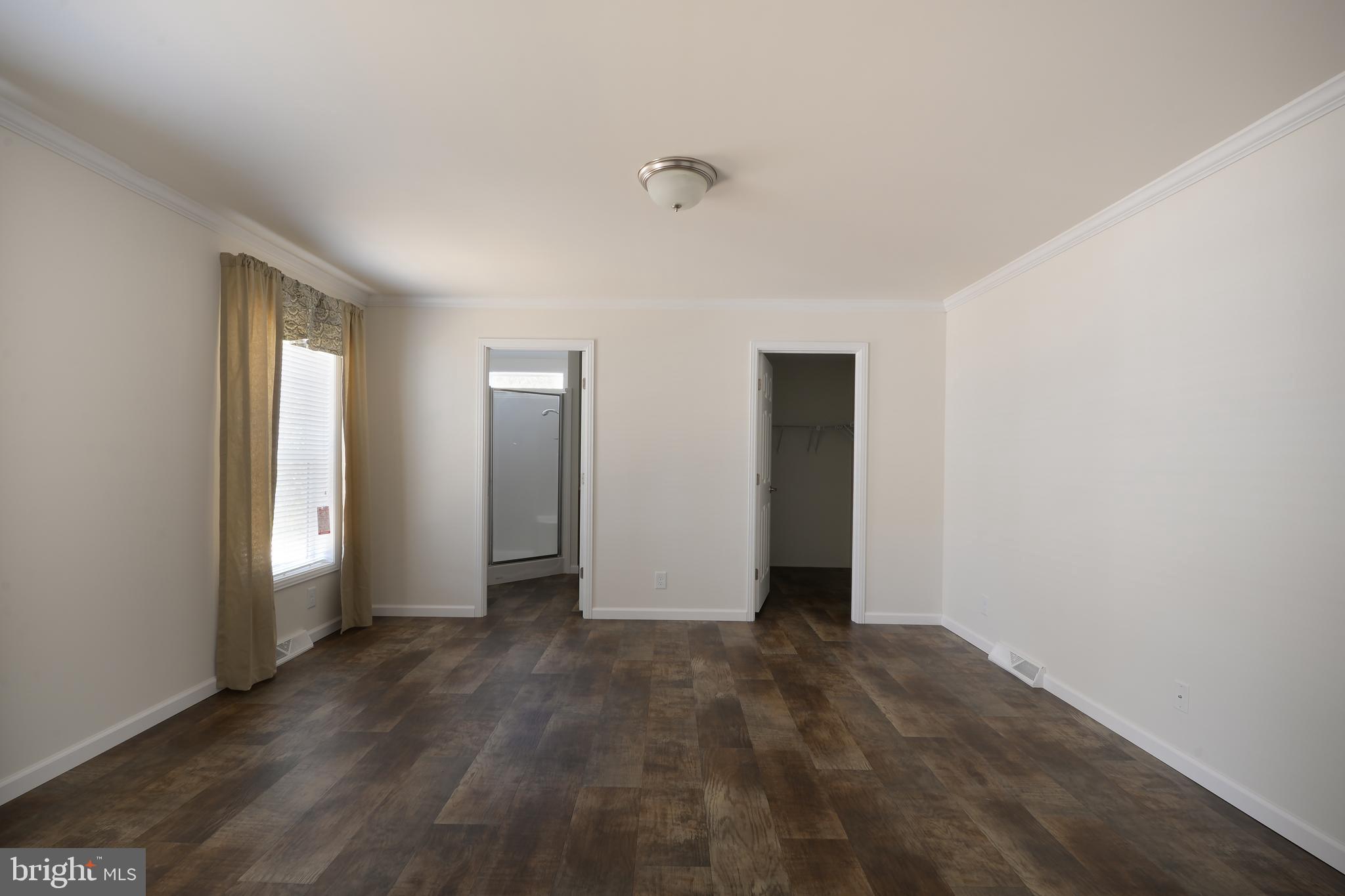 8 Edgewater Drive, Unit 8 Magnolia, DE 19962 - Photo 4 of 13 a view of an empty room with wooden floor and closet