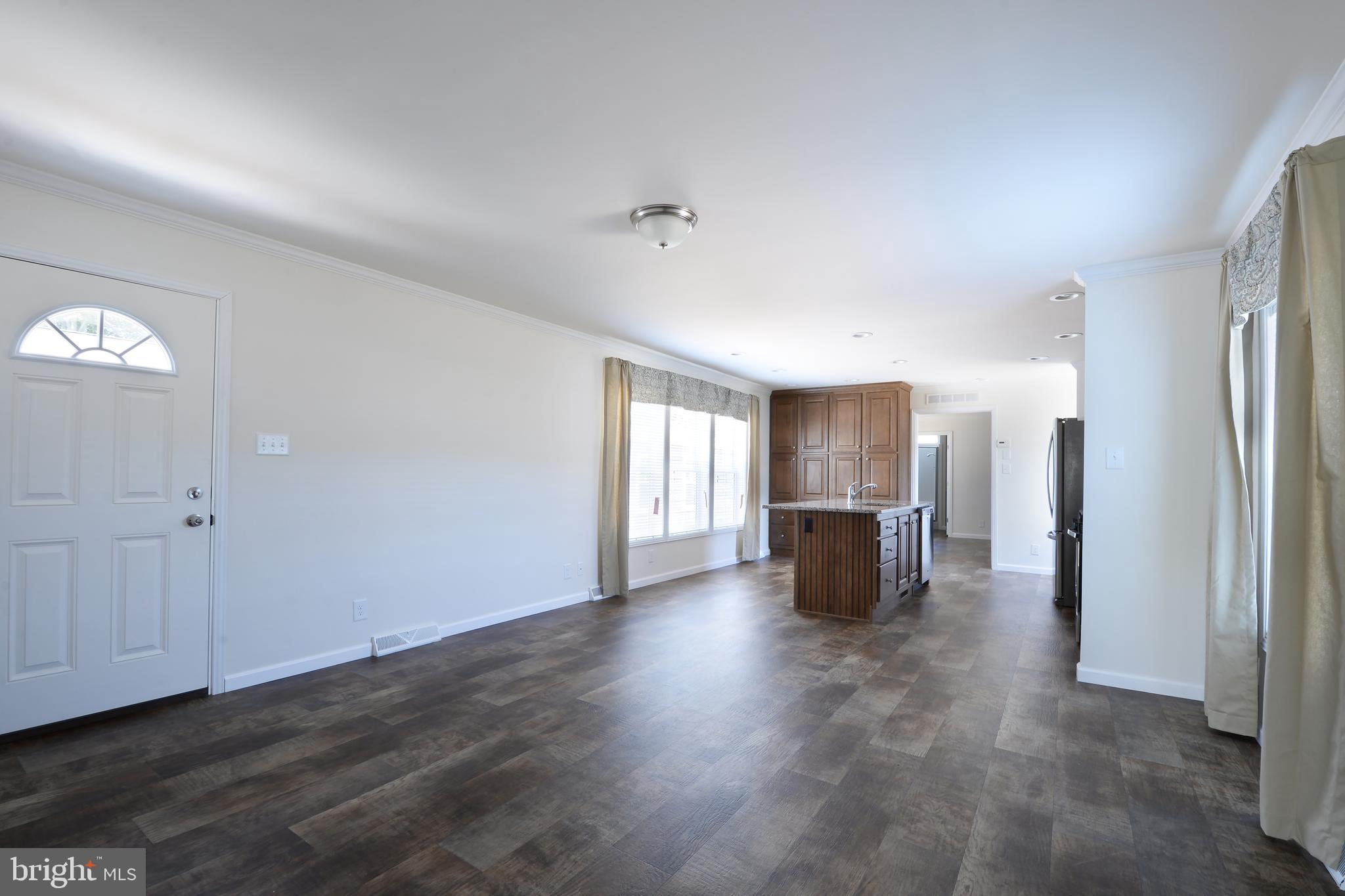 8 Edgewater Drive, Unit 8 Magnolia, DE 19962 - Photo 9 of 13 an empty room with wooden floor and fireplace