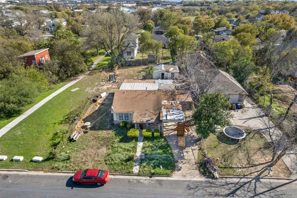 an aerial view of a house with a yard