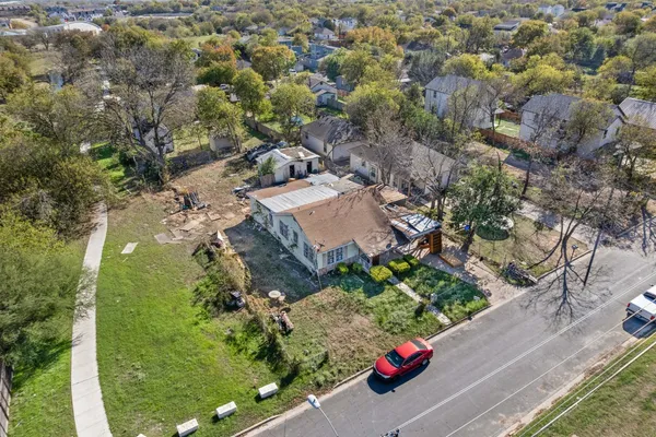 an aerial view of a house with a yard