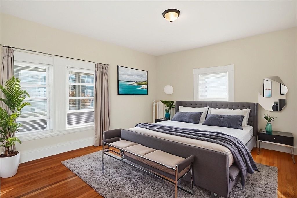 10 Charles Street, Unit 2 Winthrop, MA 02152 - Photo 11 of 22 a bedroom with a bed and wooden floor