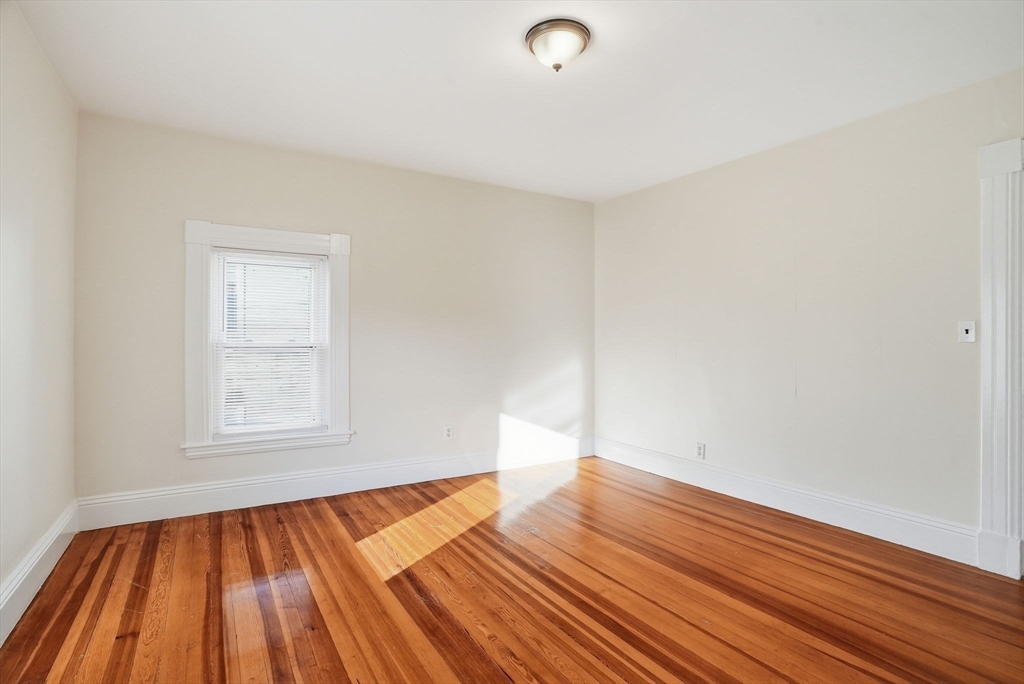 10 Charles Street, Unit 2 Winthrop, MA 02152 - Photo 2 of 22 an empty room with wooden floor and windows