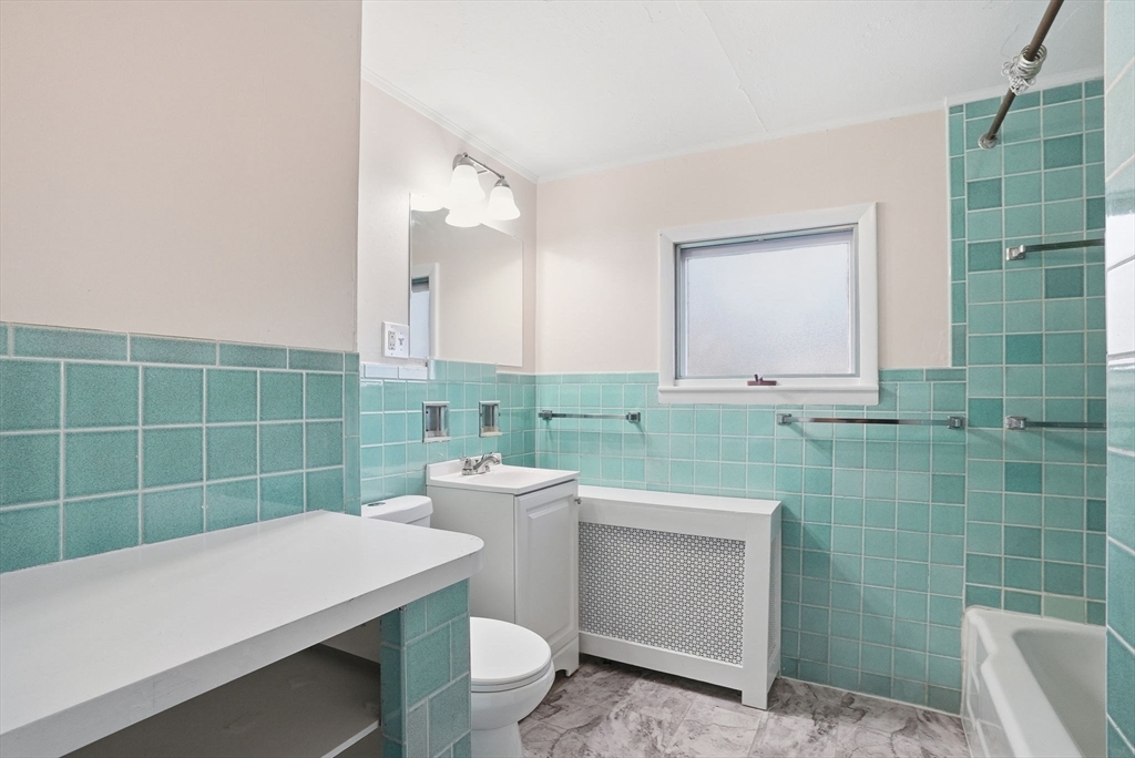 10 Charles Street, Unit 2 Winthrop, MA 02152 - Photo 21 of 22 a bathroom with a sink a toilet and a mirror