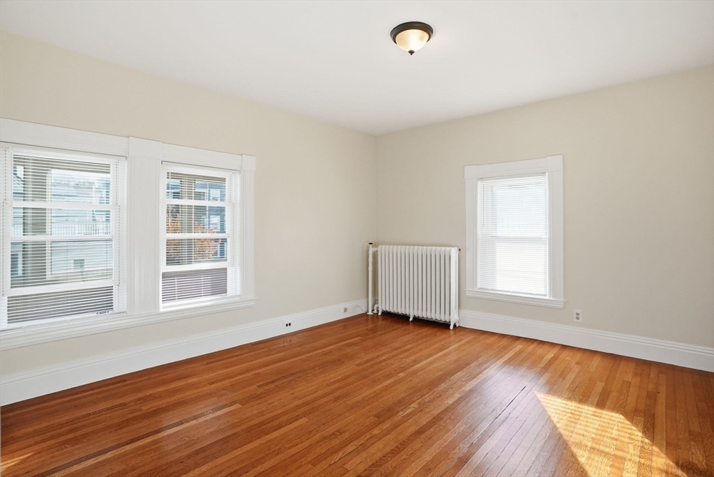 10 Charles Street, Unit 2 Winthrop, MA 02152 - Photo 10 of 22 a view of an empty room with wooden floor and a window