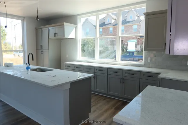a kitchen with a sink stove and refrigerator