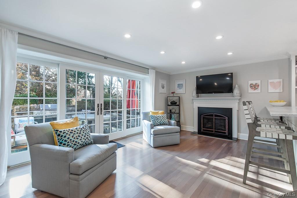 94 Round Hill Road Scarsdale, NY 10583 - Photo 16 of 46 Additional view of the sun-filled family room with direct access to the picturesque stone patio with built-in cooking area.