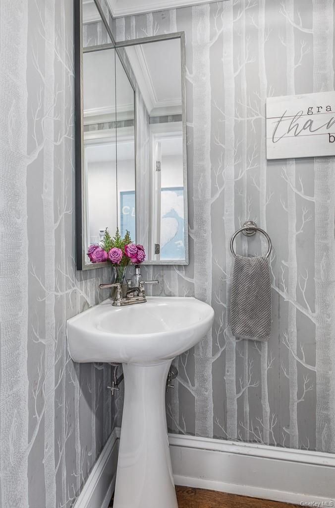 94 Round Hill Road Scarsdale, NY 10583 - Photo 19 of 46 The powder room is positioned by the entrance hall.