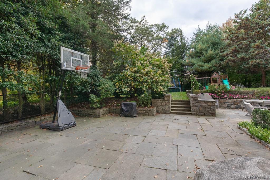 94 Round Hill Road Scarsdale, NY 10583 - Photo 38 of 46 An expansive wrap-around patio offers additional outdoor space for entertaining and a game of basketball!