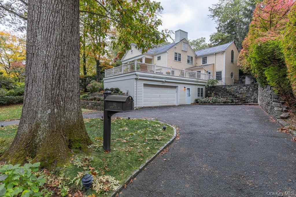 94 Round Hill Road Scarsdale, NY 10583 - Photo 43 of 46 View of the attached two-car garage and large circular driveway with ample parking.