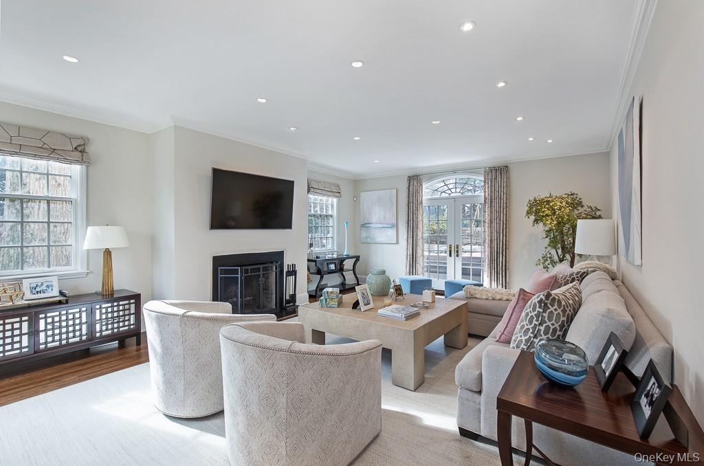 94 Round Hill Road Scarsdale, NY 10583 - Photo 5 of 46 Alternative view of the grand living room showcases the large windows and access to the stone patio and property.