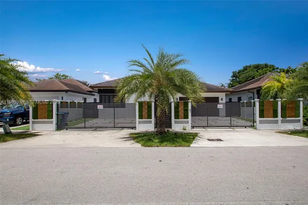 a palm tree in front of a house