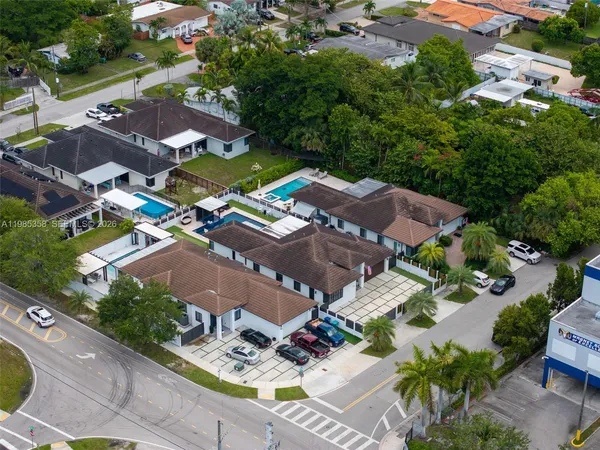 an aerial view of a house with garden space and street view