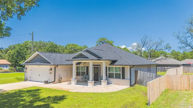 a front view of a house with a yard table and chairs