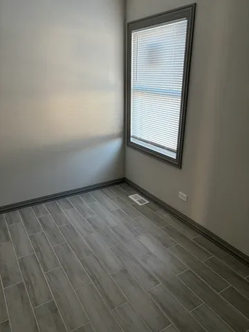 an empty room with wooden floor and closet