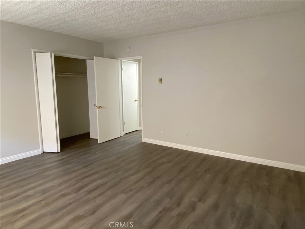 320 North Stoneman Avenue, Unit E Alhambra, CA 91801 - Photo 2 of 6 a view of an empty room with wooden floor and closet