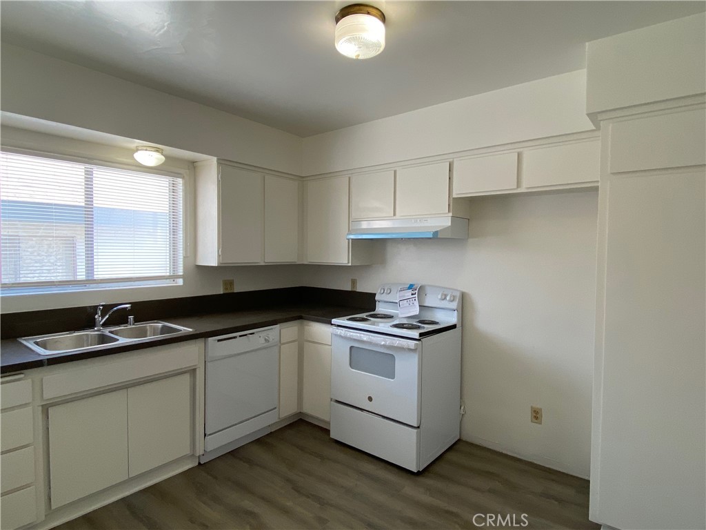 320 North Stoneman Avenue, Unit E Alhambra, CA 91801 - Photo 3 of 6 a kitchen with stainless steel appliances granite countertop a sink a stove and cabinets