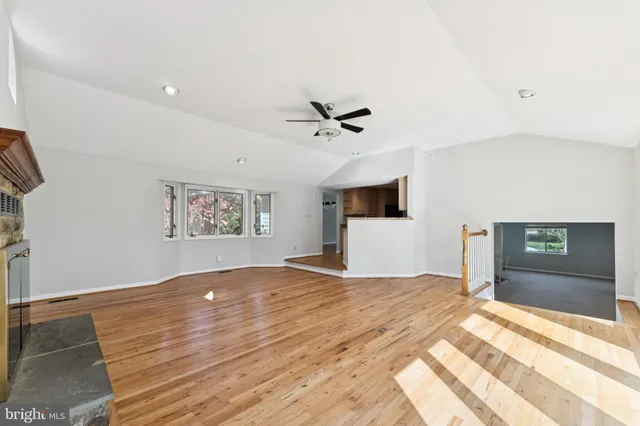 a workspace with wooden floor and a ceiling fan