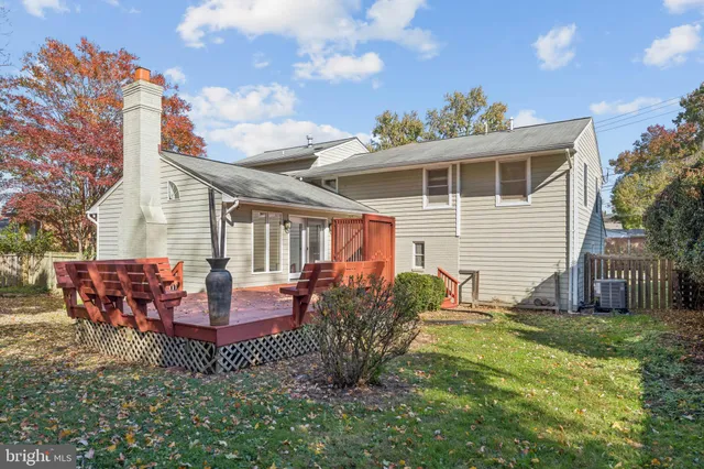a view of a house with a yard and wooden fence