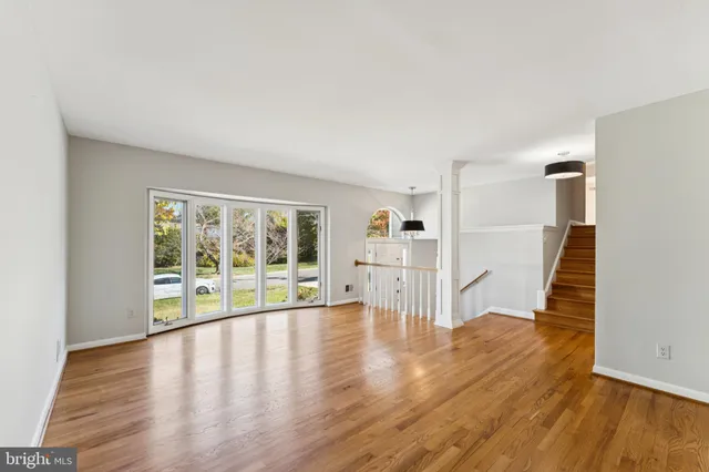 wooden floor in an empty room with a window and wooden floor