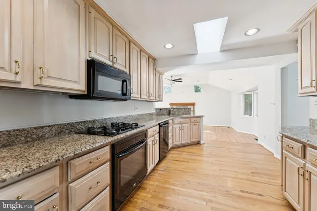 a kitchen with stainless steel appliances granite countertop a stove a sink and a granite counter tops